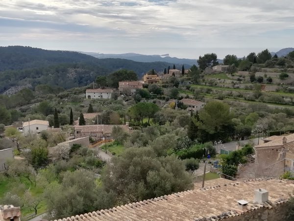 The hamlet of Galilea among terraces and pines