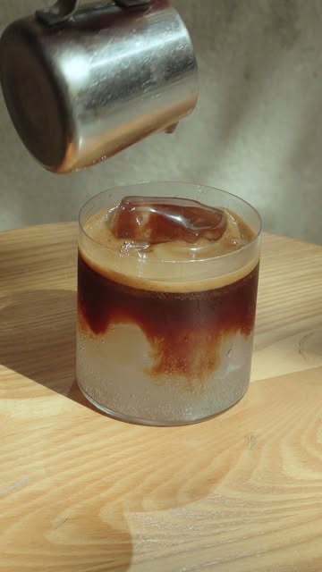 An iced coffee being poured at Mistral